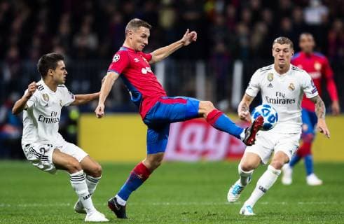 MOSCOW, RUSSIA - OCTOBER 2, 2018: Real Madrid s Sergio Reguilon, CSKA Moscow s Fyodor Chalov, and Real Madrid s Toni Kroos (L-R) fight for the ball in their 2018 19 UEFA Champions League Group G Round 2 football match at Luzhniki Stadium. Valery Sharifulin TASS  TS0923CA