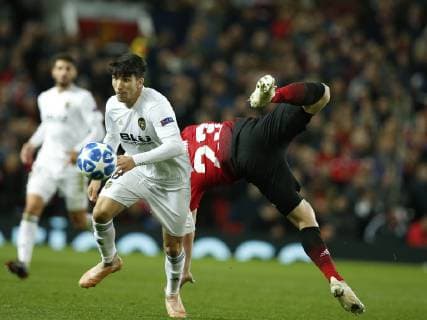 Luke Shaw of Manchester United ManU challenges Carlos Soler of Valencia during the UEFA Champions League Group H match at Old Trafford Stadium, Manchester. Picture date: 2nd September 2018. Picture credit should read: Andrew Yates Sportimage EDITORIAL USE ONLY. No use with unauthorised audio, video, data, fixture lists, club league logos or live services. Online in-match use limited to 120 images, no video emulation. No use in betting, games or single club league player publications.