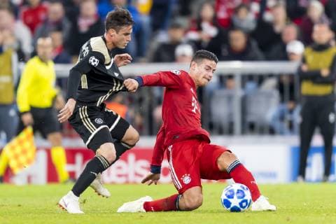 GER UEFA CL Bayern Muenchen GER vs Ajax Amsterdam NED 02 10 2018 Allianz Arena Muenchen GER UEFA CL Bayern Muenchen GER vs Ajax Amsterdam NED Group E UEFA regulations prohibiting any use of photographs Nicolas Tagliafico Ajax 31 in the fight with James Rodriguez FCB 11 nordphotox xStraubmeier nph00004