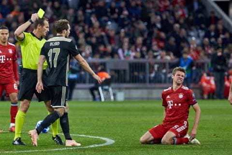 Muenchen Germany 02 10 2018 UEFA Champions League 2018 19 Season Preliminary Group E Match 02 FC Bayern Muenchen Ajax Amsterdam Referee Pavel Kralovec Czech Republic is shown a yellow card DeFodi501 by Daley Blind Ajax Amsterdam