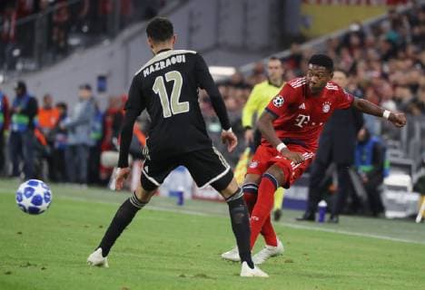 Champions League Match FC Bayern München Ajax Amsterdam 1 1 David Alaba shoots Noussair Mazraoui looks to DFL regulations prohibit any use of images Munich Bayern Germany Allianz Arena