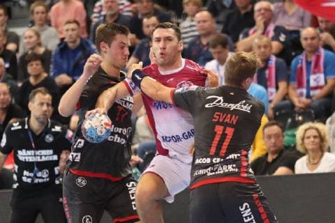 SG Flensburg Handewitt vs HC Motor Zaporozhye Handball EHF Champions League Group Stage 03 10 18 Barys Pukhouski HC Motor Zaporozhye 10 against Magnus Roed SG Flensburg Handewitt 77 and Lasse Svan Hansen SG Flensburg Handewitt 11 xmmkx