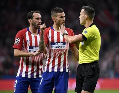 MADRID, SPAIN - OCTOBER 3 : referee Ivan Kruzliak (SVK) and Diego Godin of Atletico de Madrid and Lucas Hernandez of Atletico de Madrid pictured during the UEFA Champions League Group A stage match between Club Brugge and Atletico de Madrid at Estadio Metropolitano on October 3, 2018 in Madrid Spain , 03 10 2018 ( FOOTBALL : Ligue des champions - Group Stage - Groupe A - Atletico Madrid v Club Brugge - 03 10 2018 PHOTONEWS PANORAMIC  775218867
