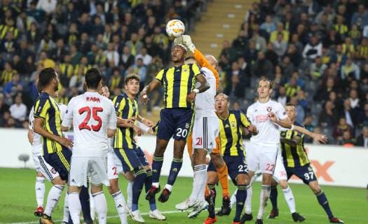 Andre Ayew of Fenerbahce and Goalkeeper Martin Chudy of Spartak Trnava during the UEFA Europa League Group D match between Fenerbahce and Spartak Trnava at Ulker Stadium in Istanbul , Turkey on October 04 , 2018 