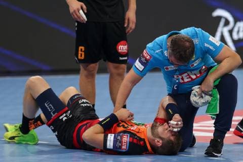 Steffen Fäth RNL 23 has to be treated after a slap in the face injured injury injured sporting injury Action Action Game scene Handball Champions League Rhein Neckar Löwen IFK Kristianstad xozx