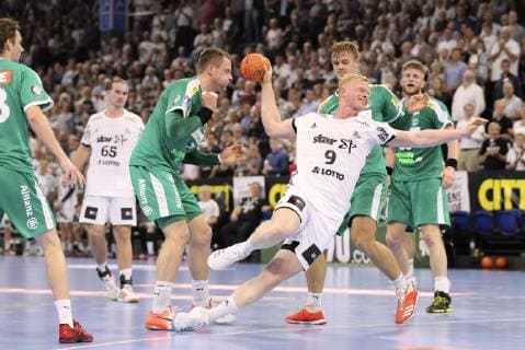 Photo Goal of Sebastian Firnhaber against Pieczkowski Leipzig and Aivis Jurdzs left Handball 1 Bundesliga Cup match on Wed 17 10 2018 THW Kiel DHfK Leipzig 31 23