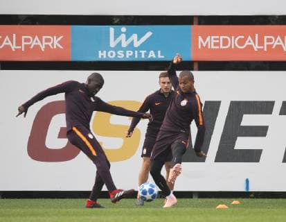 Galatasaray s Players Badou Ndiaye (L) and Mariano (R) attend a training session at the Florya training ground in Istanbul on October 23, 2018 on the eve of the UEFA Champions League football match between Galatasaray and FC Schalke 04.. 
