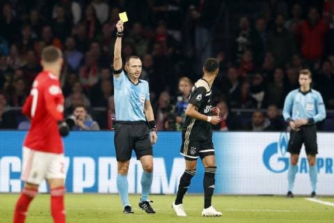 AMSTERDAM, Stadium Johan Cruyff Arena 23-10-20-18, football, season 2018 2019, Football Champions League . referee Rudy Buquet gives yellow card to Ajax player Noussair Mazraoui (R) during the game Ajax - Benfica . Ajax - Benfica  x2562437x
