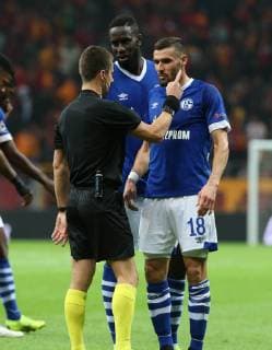 Referee Benoit Bastian and Salif Sane and Damiel Caligiuri of FC Schalke 04 during the UEFA Champions League Group D match between Galatasaray and FC Schalke 04 at Turk Telekom Stadium in Istanbul , Turkey on October 24 , 2018. 
