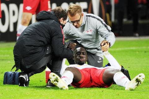 UEFA Europa League 2018 2019 Group Stage Group Stage 3 Gameday RB Leipzig vs Celtic FC Glasgow 25 10 2018 Jean Kevin Augustin RBL center is injured on the ground the RBL Physiotherapist Christopher Weichert re and Nikolaus Schmidt li help him up Leipzig Saxony Germany