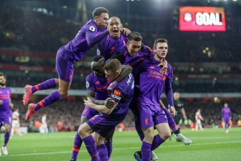 Football - 2018 2019 Premier League - Arsenal vs. Liverpool Liverpool players congratulate goal scorer James Milner (Liverpool FC) as they celebrate in front of their fans at The Emirates. COLORSPORT DANIEL BEARHAM  csp_ars_liv_031118_