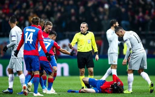 MOSCOW, RUSSIA â€“ NOVEMBER 7, 2018: Referee Cuneyt Cakir (C standing) and CSKA Moscowâ€™s Mario Fernandes (C) injured in their 2018 19 UEFA Champions League Group G Round 4 football match against AS Roma at Luzhniki Stadium. Valery Sharifulin TASS  TS0969A2