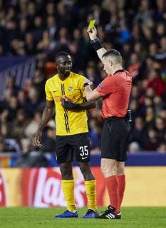 7th November 2018, Mestalla Stadium, Valencia, Spain; UEFA Champions League football, Valencia versus Young Boys; Midfielder Sekou Sanogo Junior receives a yellow card from referee Istvan Kovacs  ActionPlus12077118 IvanxArlandis