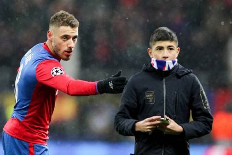 MOSCOW, RUSSIA â€“ NOVEMBER 27, 2018: CSKA Moscow s Nikola Vlasic (L) and a pitch invader in their 2018 19 UEFA Champions League Group G Round 5 football match against FC Viktoria Plzen at Luzhniki Stadium. Sergei Bobylev TASS  TS09900A