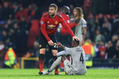 Manchester United ManU s Eric Bailly consoles Mohamed Ali Camara of BSC Young Boys at full time during the UEFA Champions League match at Old Trafford, Manchester. Picture date 27th November 2018. Picture credit should read: Matt McNulty Sportimage EDITORIAL USE ONLY. No use with unauthorised audio, video, data, fixture lists, club league logos or live services. Online in-match use limited to 120 images, no video emulation. No use in betting, games or single club league player publications.