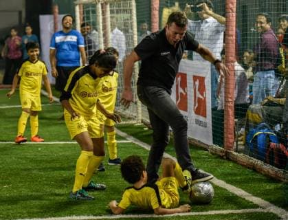 MUMBAI, INDIA DECEMBER 5: Former German football captain Lothar Matthaus plays with children during a football clinic organised by Indo German chambers and Bundesliga at Cooperage Ground, Nariman Point, on December 5, 2018 in Mumbai, India. (Photo by Kunal Patil Hindustan Times ) Former German football captain Lothar Matthaus In India
