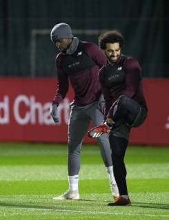 10th December 2018, Melwood, Liverpool, England, UEFA Champions League football, Liverpool versus Napoli, Liverpool training at Melwood ; Divock Origi and Mohamed Salah of Liverpool warm up at the start of the session  ActionPlus12086625 DavidxBlunsden