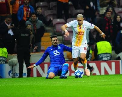 Sofiane Feghouli (R) of Galatasaray and Alex Telles (L) of Porto during the Champions League group D match between Galatasaray and Porto at Turk Telkom Stadium n Istanbul , Turkey on December 11 , 2018. 