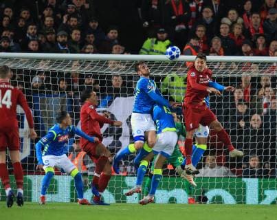 11th December 2018, Anfield, Liverpool, England; UEFA Champions League football, Liverpool versus Napoli; Roberto Firmino of Liverpool out jumps Raul Albiol of Napoli to win a header  ActionPlus12086821 DavidxBlunsden