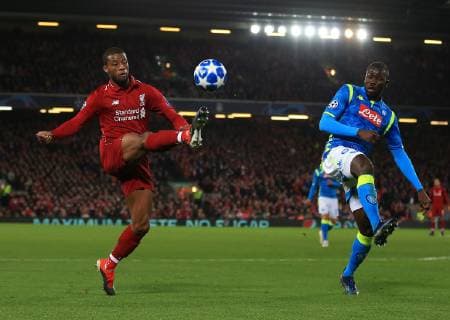 11th December 2018, Anfield, Liverpool, England; UEFA Champions League football, Liverpool versus Napoli; Georginio Wijnaldum of Liverpool lobs the ball over the head of Kalidou Koulibaly of Napoli  ActionPlus12086869 DavidxBlunsden