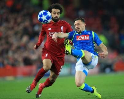 11th December 2018, Anfield, Liverpool, England; UEFA Champions League football, Liverpool versus Napoli; Mario Rui of Napoli tackles Mohamed Salah of Liverpool  ActionPlus12086929 DavidxBlunsden
