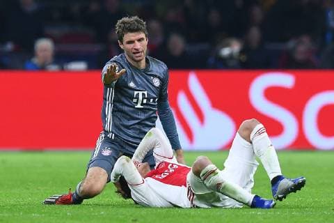 Football Champions League Group Phase 6 Matchday Ajax Amsterdam FC Bayern Munich on 12 12 2018 in the Johann Cruyff ArenA in Amsterdam Nicolas Tagliafico Amsterdam front Thomas Müller Munich rear DFL Regulations prohibit any use of photographs as image sequences and or quasi video xRx