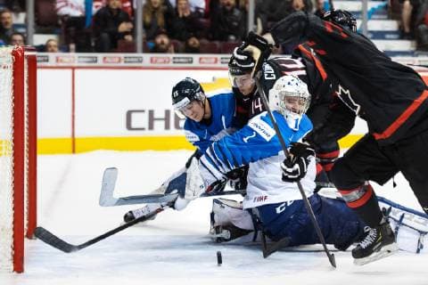 181223 Henri Jokiharju and goaltender Ukko Pekka Luukkonen of Finland are being challenged by Maxime Comtois and Twin Tippett of Canada during the U20 ice hockey game between Finland and Canada on December 23 2018 in Vancouver Photo Joel Marklund BILDBYR u0081N kod JM 87821, detectedSourceLanguage  Copyright: JOELxMARKLUND BB181223JM019