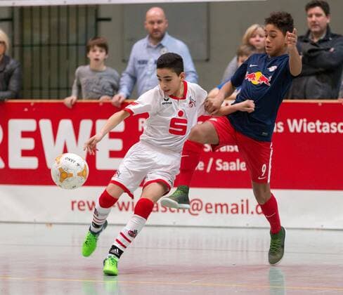 The Cologne Birol Adibelli l holds his ground against Leipzigs Armindo Sieb r in the final between 1 FC Köln and RB Leipzig at the 21 international indoor football tournament Junior Masters in the sports hall Bildungszentrum in Halle Neustadt on 24 01 16