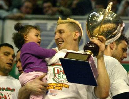 His daughter Lucie shows handball national player Stefan Krezschmar the cup as winner of the Handball Champions League during the award ceremony in Magdeburg on Saturday 27 April 2002 SC Magdeburg won the final return match against the Hungarian champion Fotex KC Veszprem 30 25 Eckehard Schulz MAGDEBURG DEU