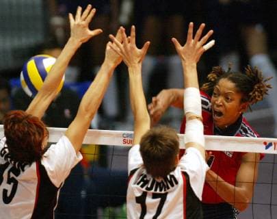 Prikeba Phipps right of U S smashes against Angelina Gruen left and Birgit Thumm of Germany during the Women s Volleyball World Championship second round match Germany vs U S in Riesa eastern Germany Sunday Sept 8 2002 Eckehard Schulz RIESA DEU