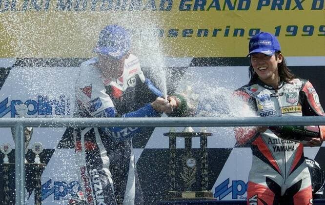 3rd placed Japanese rider Norick Abe right sprays Champagne on the winner of the 500cc race of German motor cycling World Cup at the Sachsenring circuit U S rider Kenny Roberts junior left during the winner ceremony on Sunday July 18 1999 Eckehard Schulz SACHSENRING DEU