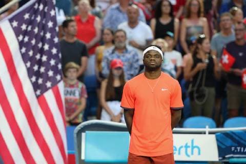 Frances Tiafoe stands next to the flag while the national anthem is played Copyright: xJuergenxHasenkopfx
