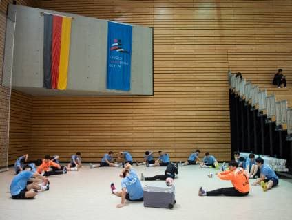The players sit on the ground during the gymnastics handball public training of the joint handball team from North and South Korea in preparation for the Handball World Championship 2019 in DEN GER at the Horst Kober Sports Center in Berlin Germany on 04 01 2019