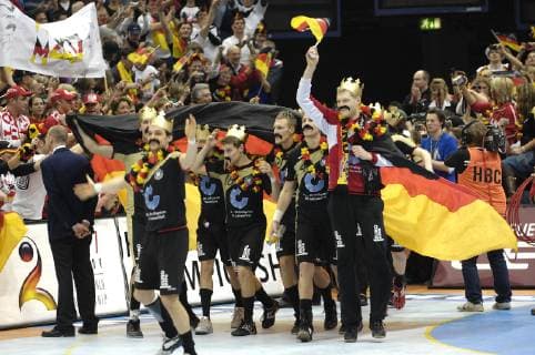 Entry of the German handball national team to the award ceremony the players wear golden crowns and moustaches after the example of national coach Heiner Brand after the final whistle cheering final cheering award ceremony final final match Germany GER Poland POL 29 24 on 04 02 2007 in Cologne world champion Germany handball world championship 2007 in Germany from 19 01 04 02 2007