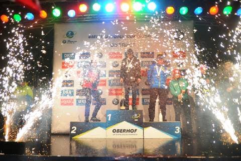 Award ceremony after the womens Biathlon World Cup sprint races 10 01 2019 and the mens sprint races 11 01 2019 Fireworks and champagne shower at the mens award ceremony with Alexander Lginow RUS middle Johannes Thingnes Bö NOR li Sebastian Samuelsson SWE re Bö opened his champagne bottle and sprayed it into the audience Oberhof Thüringen Germany