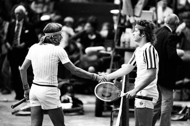 John Mc ENROE re USA and Bjoern BORG Sweden reach out after the final of Wimbledon 1980 at the net the hand handshake congratulations winner Bjoern Borg landscape tennis black and white 29 06 1980 Â