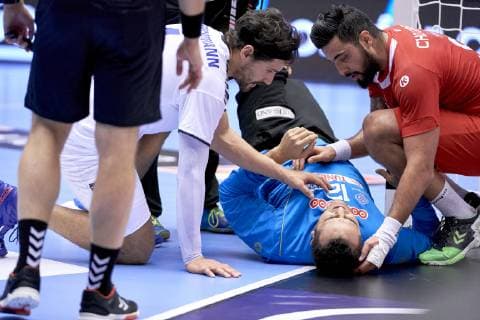 IHF Men s World Championship WM Weltmeisterschaft 2019 Group C handball match. A injured Marouen Maggaiz (12) of Tunisia between Erwin Feuchtmann (4) of Chile and Marouan Chouiref (90) of Tunisia during the men s IHF Handball World Championship Group C match 31 between Tunisia and Chile at the Jyske Bank Boxen arena in Herning Denmark on Monday January 14, 2019. Denmark 