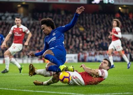 Football - 2018 2019 Premier League - Arsenal vs. Chelsea Resolute defending from Sokratis Papastathopoulos (Arsenal FC) as he times his tackle on Willian (Chelsea FC) at The Emirates. COLORSPORT DANIEL BEARHAM  csp_ars_che_190119_
