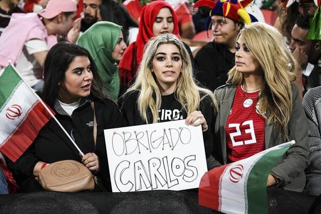 Iran fans wave slogans and national flags to show support to Iran national men s football team in their quarter-final match against China during the 2019 AFC Asian Cup in Abu Dhabi, United Arab Emirates, 24 January 2019. Iran fans cheer for quarter-final match against China  scr161753