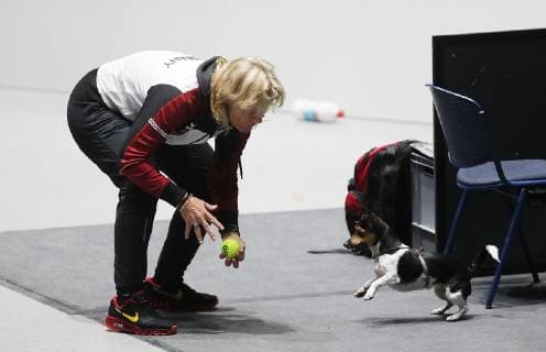 Barbara Rittner is playing with her dog during the training.