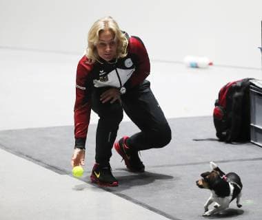Barbara Rittner is playing with her dog during the training.