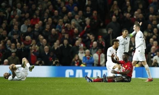 Dani Alves of PSG rolls about to get Paul Pogba of Manchester United ManU sent off during the UEFA Champions League Round of 16 First Leg match at the Old Trafford Stadium, Manchester. Picture date: 12th February 2019. Picture credit should read: Andrew Yates Sportimage EDITORIAL USE ONLY. No use with unauthorised audio, video, data, fixture lists, club league logos or live services. Online in-match use limited to 120 images, no video emulation. No use in betting, games or single club league player publications. _AY20892.JPG