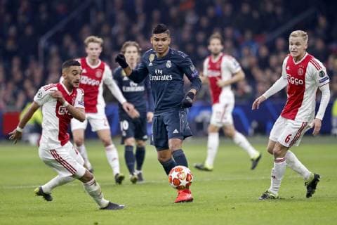 AMSTERDAM, Ajax - Real Madrid, football, Champions League Season 2018 2019, 13-02-2019, Johan Cruijff Arena. Real Madrid player Casemiro (C) and Ajax player Hakim Ziyech (L) and Ajax player Donny van de Beek (R) during the game Ajax - Real Madrid. Ajax - Real Madrid  x2820784x