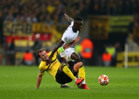13th February 2019, Wembley Stadium, London England; UEFA Champions League football, Tottenham Hotspur versus Borussia Dortmund; Davinson Sanchez of Tottenham Hotspur out-muscles Mario Gotze of Borussia Dortmund  ActionPlus12105235 JohnxPatrickxFletcher