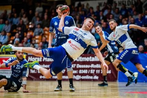 Handball 2 Bundesliga Men Season 2018 2019 Dessau Rosslauer HV 06 VfL Lübeck Schwartau Philip Jungemann 21 Dessau Rosslauer HV 06 with Marino Mallwitz 1 VfL Lübeck Schwartau during the season 2018 2019 in the Handball 2 Bundesliga Men between Dessau Rosslauer HV 06 and VfL Lübeck Schwartau in the Anhalt Arena on 17 February 2019 in Bauhausstadt Dessau Saxony Anhalt Saxony Anhalt Germany