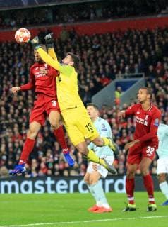 19th February 2019, Anfield, Liverpool, England; UEFA Champions League round of 16, Liverpool versus Bayern Munich; Liverpool goalkeeper Alisson Becker leaps above Fabinho of Liverpool to punch the ball clear from a corner  ActionPlus12106779 DavidxBlunsden
