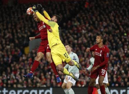 Fabinho and Alisson Becker of Liverpool combine to keep out Robert Lewandowski of Bayern Munich during the UEFA Champions League Round of 16 First Leg match at Anfield Stadium, Liverpool. Picture date: 19th February 2019. Picture credit should read: Darren Staples Sportimage EDITORIAL USE ONLY. No use with unauthorised audio, video, data, fixture lists, club league logos or live services. Online in-match use limited to 120 images, no video emulation. No use in betting, games or single club league player publications. _AZ12736.JPG