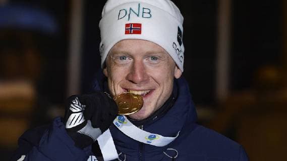 Biathlon World Championship in Östersund Sweden Mens sprint award ceremony on 09 03 2019 Johannes Thingnes Boe Norway bites gold medal at Medals Ceremony after mens sprint race during Biathlon World Championships in Östersund Sweden 09 03 2019 Östersund Jämtland Sweden Medals Plaza