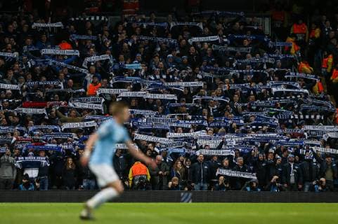 FC Schalke 04 fans hold up scarves during the UEFA Champions League Round of 16 match at the Etihad Stadium, Manchester. Picture date: 12th March 2019. Picture credit should read: James Wilson Sportimage EDITORIAL USE ONLY. No use with unauthorised audio, video, data, fixture lists, club league logos or live services. Online in-match use limited to 120 images, no video emulation. No use in betting, games or single club league player publications. SPI_3403.JPG