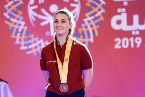 March 17, 2019 - Abu Dhabi, United Arab Emirates - Cypriot athlete shows her emotions when receiving their medals during declaration ceremony at the Special Olympics World Games in Abu Dhabi National Exhibition Centre, United Arab Emirates on March 17, 2019. Special Olympics is a worldwide organization which organize sports competitions for people with learning difficulties. Summer World Games take place every 4 years. 7500 athletes from nearly 200 countries compete in 24 Olympic disciplines in Abu Dhabi Games in 2019. Opening Ceremony Of Special Olympics 2019 In Abu Dhabi  - ZUMAn230 20190317_zaa_n230_623 Copyright: xDominikaxZarzyckax